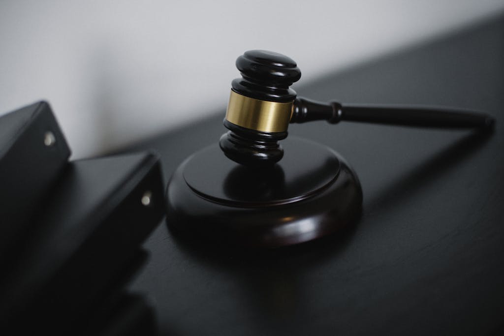 Close-up of a wooden gavel on a desk, symbolizing justice and legal authority.